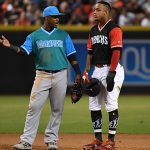 Ketel Marte  talks with Jean Segura of the Seattle Mariners during a stop in play at Chase Field. All players across MLB will wear nicknames on their backs as well as colorful, non-traditional uniforms featuring alternate designs inspired by youth-league uniforms during Players Weekend.  (Photo by Norm Hall/Getty Images)