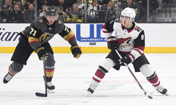 Clayton Keller #9 of the Arizona Coyotes skates with the puck against William Karlsson #71 of the V...