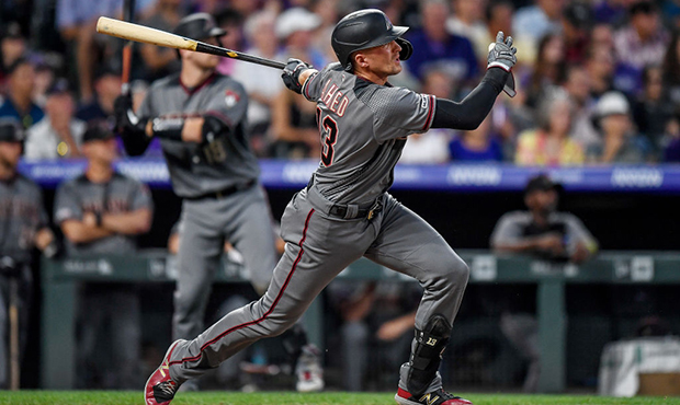 Nick Ahmed #13 of the Arizona Diamondbacks hits a two-run double in the fourth inning of a game aga...