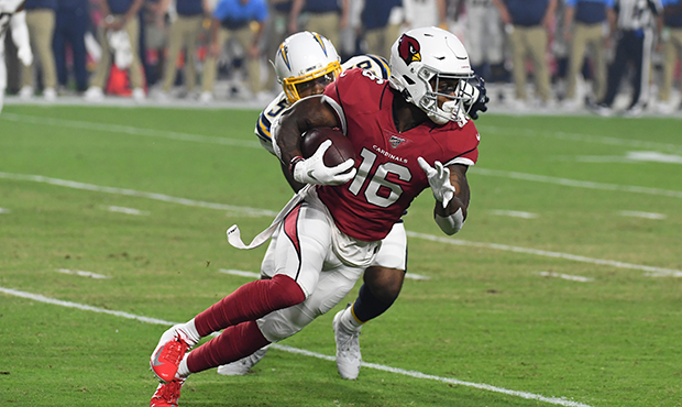 Trent Sherfield #16 of the Arizona Cardinals runs with the ball while being defended by Kyle Wilson...