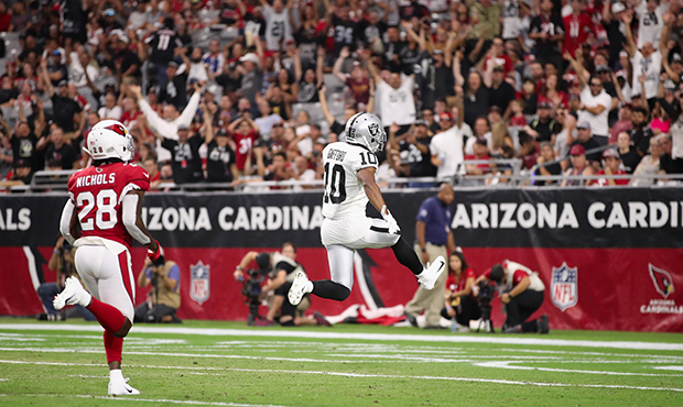 Wide receiver Rico Gafford #10 of the Oakland Raiders scores a 53 yard touchdown reception ahead of...