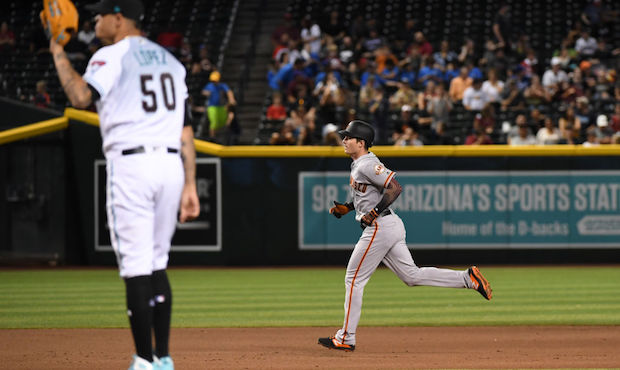 Mike Yastrzemski #5 of the San Francisco Giants rounds the bases after hitting a solo home run duri...