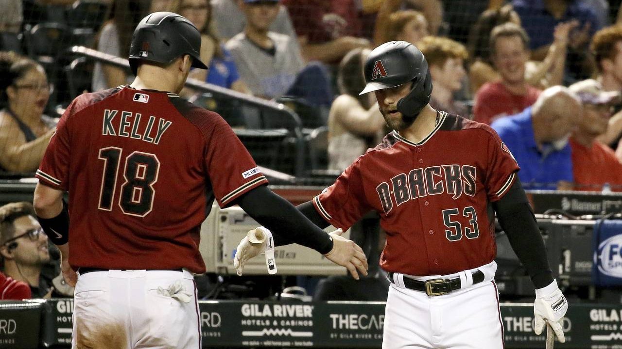Arizona Diamondbacks' Carson Kelly (18) is greeted by Christian Walker (53) after scoring against t...