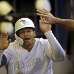 Milwaukee Brewers' Trent Grisham is congratulated in the dugout after hitting a solo home run during the fourth inning of a baseball game against the Arizona Diamondbacks, Saturday, Aug. 24, 2019, in Milwaukee. (AP Photo/Aaron Gash)