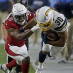 Los Angeles Chargers running back Austin Ekeler (30) is hit by Arizona Cardinals defensive back Rudy Ford, left, during the first half of an NFL preseason football game, Thursday, Aug. 8, 2019, in Glendale, Ariz. (AP Photo/Rick Scuteri)