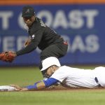 New York Mets' Luis Guillorme Slides safely into second next to Atlanta Braves second baseman Ozzie Albies with a double during the second inning of a baseball game Friday, Aug. 23, 2019, in New York. (AP Photo/Mary Altaffer)
