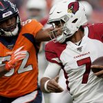 Arizona Cardinals quarterback Brett Hundley (7) tries to elude the reach of Denver Broncos linebacker Justin Hollins (52) during the first half of an NFL preseason football game, Thursday, Aug. 29, 2019, in Denver. (AP Photo/Jack Dempsey)