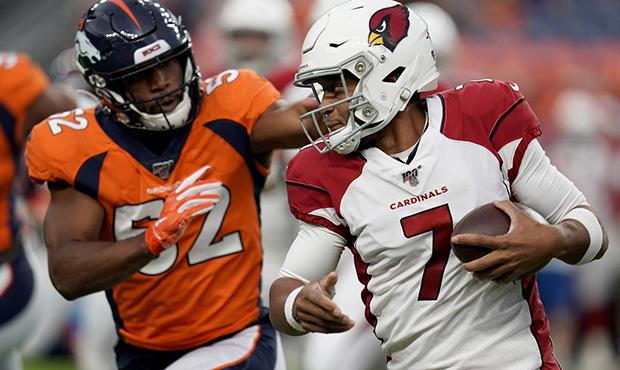 Arizona Cardinals quarterback Brett Hundley (7) tries to elude the reach of Denver Broncos lineback...