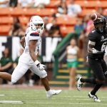 Hawaii wide receiver Cedric Byrd II (6) pulls in a pass next to Arizona safety Christian Young (5) during the first quarter of an NCAA college football game Saturday, Aug. 24, 2019, in Honolulu. (AP Photo/Marco Garcia)