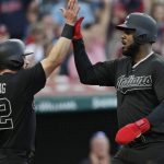 Cleveland Indians' Jason Kipnis, left, and Franmil Reyes celebrate after both scored on a two-run single by Tyler Naquin in the second inning of a baseball game against the Kansas City Royals, Friday, Aug. 23, 2019, in Cleveland. (AP Photo/Tony Dejak)