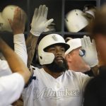 Milwaukee Brewers' Eric Thames is congratulated after hitting a home run during the third inning of a baseball game against the Arizona Diamondbacks Friday, Aug. 23, 2019, in Milwaukee. (AP Photo/Morry Gash)