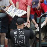 Colorado Rockies' Yonder Alonso signs autographs before the team's baseball game against the St. Louis Cardinals on Friday, Aug. 23, 2019, in St. Louis. (AP Photo/Jeff Roberson)