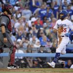 Los Angeles Dodgers' Russell Martin, right, scores on a single by Kristopher Negron as Arizona Diamondbacks catcher Alex Avila stands at the plate during the third inning of a baseball game Saturday, Aug. 10, 2019, in Los Angeles. (AP Photo/Mark J. Terrill)