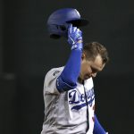 Los Angeles Dodgers' Joc Pederson takes his helmet off after hitting a pop fly for an out during the fourth inning of the team's baseball game against the Arizona Diamondbacks on Thursday, Aug. 29, 2019, in Phoenix. (AP Photo/Ross D. Franklin)