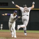 Arizona Diamondbacks first baseman Christian Walker tags out San Francisco Giants' Buster Posey to complete a double play during the sixth inning of a baseball game Thursday, Aug. 15, 2019, in Phoenix. (AP Photo/Darryl Webb)