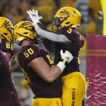 Arizona State running back Eno Benjamin (3) celebrates with teammate Jarrett Bell (50) after scoring a touchdown against Kent State during the first half of an NCAA college football game Thursday, Aug. 29, 2019, in Tempe, Ariz. (AP Photo/Ralph Freso)