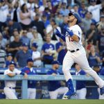 Los Angeles Dodgers' Max Muncy gestures before scoring after hitting a solo home run during the second inning of a baseball game against the Arizona Diamondbacks, Saturday, Aug. 10, 2019, in Los Angeles. (AP Photo/Mark J. Terrill)