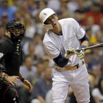 Milwaukee Brewers' Christian Yelich, right, reacts after being hit by a pitch during the seventh inning of a baseball game against the Arizona Diamondbacks, Saturday, Aug. 24, 2019, in Milwaukee. (AP Photo/Aaron Gash)
