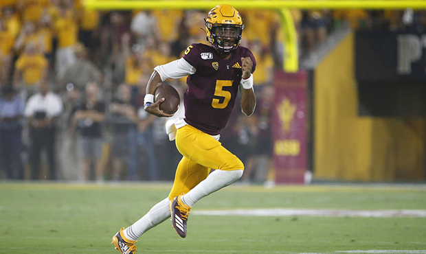 Arizona State quarterback Jayden Daniels scrambles for a first down against Kent State during the f...