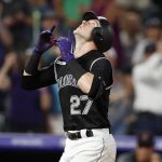 Colorado Rockies' Trevor Story gestures as he crosses home plate after hitting a solo home run off Arizona Diamondbacks starting pitcher Merrill Kelly in the fourth inning of a baseball game Monday, Aug. 12, 2019, in Denver. (AP Photo/David Zalubowski)