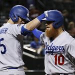 Los Angeles Dodgers' Justin Turner (10) celebrates his home run against the Arizona Diamondbacks with Cody Bellinger (35) during the ninth inning of a baseball game Thursday, Aug. 29, 2019, in Phoenix. The Diamondbacks won 11-5. (AP Photo/Ross D. Franklin)
