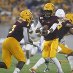 Arizona State quarterback Jayden Daniels (5) hands the ball off to running back Eno Benjamin (3) during the first half of the team's NCAA college football game against Kent State, Thursday, Aug. 29, 2019, in Tempe, Ariz. (AP Photo/Ralph Freso)
