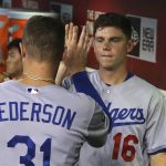 Los Angeles Dodgers' Joc Pederson (31) celebrates with Will Smith (16) after scoring against the Arizona Diamondbacks during the third inning of a baseball game Thursday, Aug. 29, 2019, in Phoenix. (AP Photo/Ross D. Franklin)