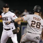 Arizona Diamondbacks' Nick Ahmed, left, forces out San Francisco Giants' Buster Posey (28) as he turns a double play against Alex Dickerson during the first inning of a baseball game, Friday, Aug. 16, 2019, in Phoenix. (AP Photo/Matt York)