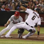 Arizona Diamondbacks' David Peralta (6) is tagged out by Philadelphia Phillies third baseman Scott Kingery (4) while trying to advance to third during the third inning of a baseball game Monday, Aug. 5, 2019, in Phoenix. (AP Photo/Ross D. Franklin)