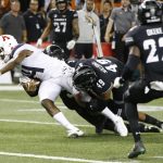 With no time left in the 4th quarter, Hawaii defensive back Kalen Hicks (3) and defensive lineman Manly Williams (49) tackle Arizona quarterback Khalil Tate (14) just short of the end zone during an NCAA college football game, Saturday, Aug. 24, 2019, in Honolulu. (AP Photo/Marco Garcia)