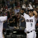 Arizona Diamondbacks' Josh Rojas (9) celebrates his two-run home run against the Los Angeles Dodgers with Jarrod Dyson during the seventh inning of a baseball game Friday, Aug. 30, 2019, in Phoenix. (AP Photo/Ross D. Franklin)