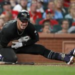 Colorado Rockies' Nolan Arenado doubles over after being hit by a pitch during the fourth inning of a baseball game against the St. Louis Cardinals Friday, Aug. 23, 2019, in St. Louis. Arenado was able to stay in the game. (AP Photo/Jeff Roberson)