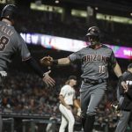 Arizona Diamondbacks' Tim Locastro, right, is congratulated by Carson Kelly (18) after scoring against the San Francisco Giants in the seventh inning of a baseball game, Monday, Aug. 26, 2019, in San Francisco. (AP Photo/Ben Margot)