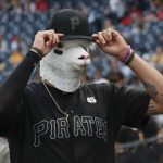 Pittsburgh Pirates' pitcher Joe Musgrove adjusts his hat while wearing a sheep mask before the team's baseball game against the Cincinnati Reds, Friday, Aug. 23, 2019, in Pittsburgh. (AP Photo/Keith Srakocic)