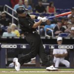 Philadelphia Phillies' J.T. Realmuto hits an RBI-double to score Cesar Hernandez during the first inning of a baseball game against the Miami Marlins, Friday, Aug. 23, 2019, in Miami. (AP Photo/Lynne Sladky)