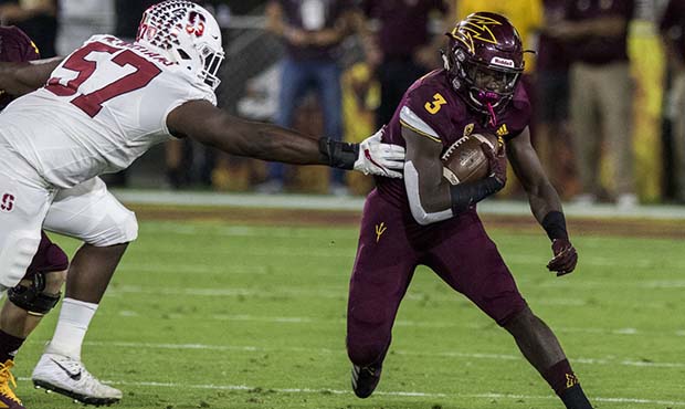 Arizona State's Eno Benjamin slips past Stanford's Michael Williams during the first half of an NCA...