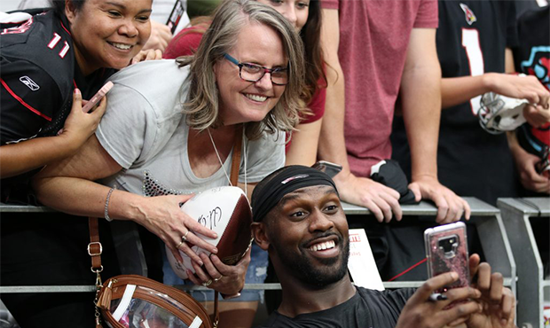 Arizona Cardinals LB Chandler Jones takes a selfie with fans following the team’s Red and White P...