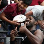Arizona Cardinals LB Chandler Jones takes a photo with a young fan following the team’s Red and White Practice Saturday, August 3, 2019, at State Farm Stadium. (Tyler Drake/Arizona Sports)