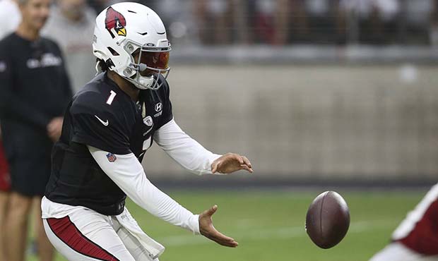 Arizona Cardinals quarterback Kyler Murray takes a snap of a football during an NFL training camp W...