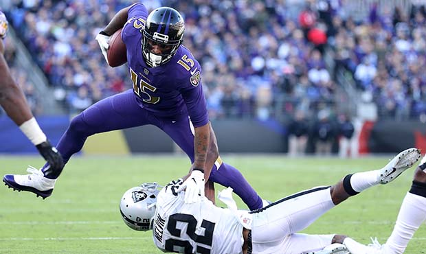Wide Receiver Michael Crabtree #15 of the Baltimore Ravens is tackled after a catch by cornerback R...