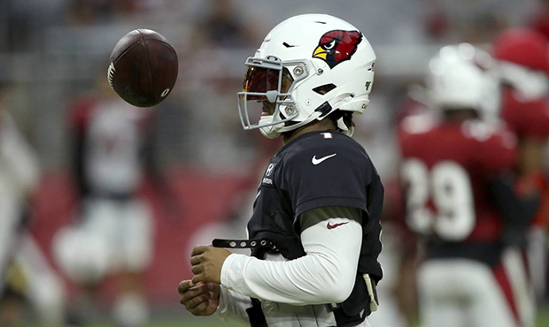 Arizona Cardinals quarterback Kyler Murray flips the ball in the air during an NFL football trainin...