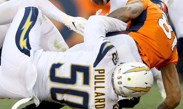 Hayes Pullard #50 of the Los Angeles Chargers forces a fumble as he tackles Tim Patrick #81 of the ...