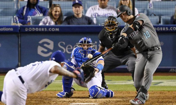 Arizona Diamondbacks' Carson Kelly, right, hits a solo home run as Los Angeles Dodgers relief pitch...