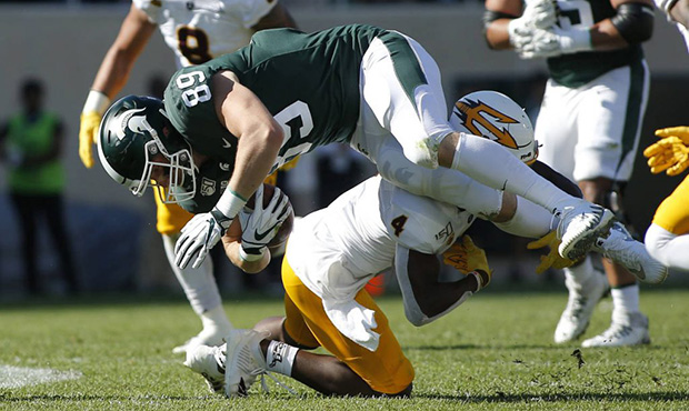 Michigan State tight end Matt Dotson (89) is upended by Arizona State's Evan Fields  after a catch ...