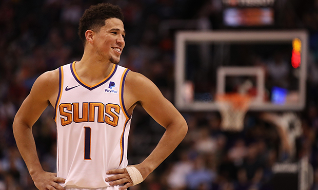 Devin Booker #1 of the Phoenix Suns reacts during the second half of the NBA game against the Milwa...