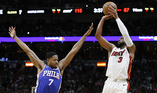 Dwyane Wade #3 of the Miami Heat shoots a three pointer over Haywood Highsmith #7 of the Philadelph...