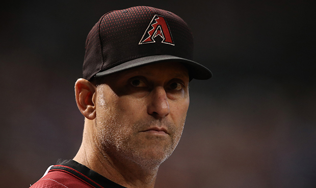 Manager Torey Lovullo #17 of the Arizona Diamondbacks watches from the dugout during the MLB game a...