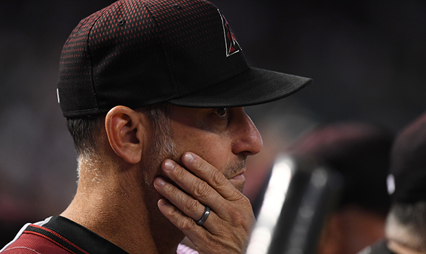 Manager Torey Lovullo #17 of the Arizona Diamondbacks looks on from the top step of the dugout duri...