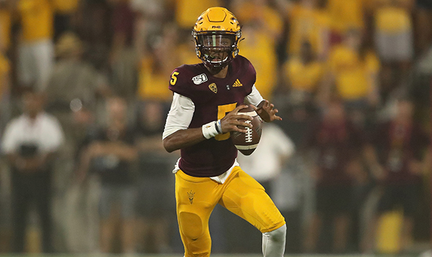 Quarterback Jayden Daniels #5 of the Arizona State Sun Devils drops back to pass during the first h...