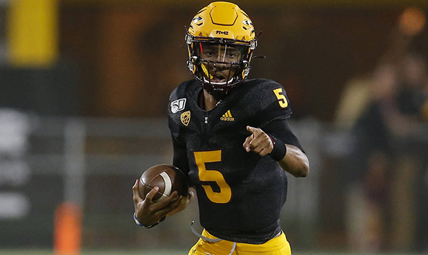 Arizona State quarterback Jayden Daniels runs for a first down against Colorado during the first ha...